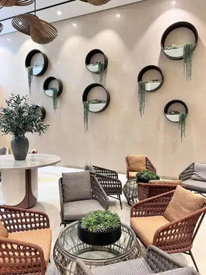a lobby with chairs and tables and mirrors on the wall at Parkwest McKinley - 1 Bedroom Fully Furnished in Manila