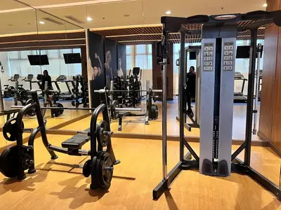 a gym with several treadmills and machines at Parkwest McKinley - 1 Bedroom Fully Furnished in Manila