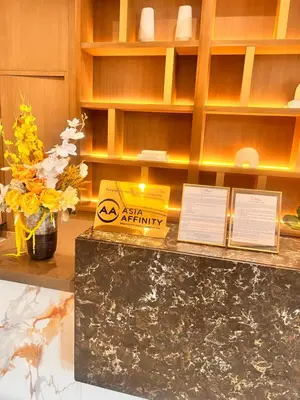 a counter with a box and flowers on it at Parkwest McKinley - 1 Bedroom Fully Furnished in Manila