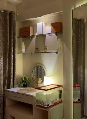 a room with a fish tank on a shelf at MOA Shell Residences Staycation in Manila