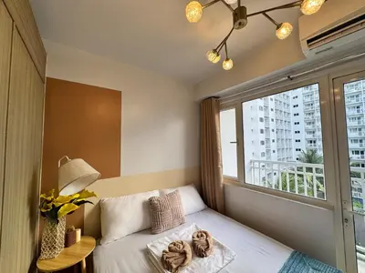 a bedroom with a bed and a large window at Shore Residences Banana Room with 2 Beds Good for 4 Guests Pool View Room 622 by Prime Stay in Manila