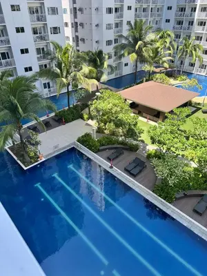 an overhead view of a swimming pool with palm trees and buildings at Shore Residences near Airport Blueberry Room 2 Beds Pool View by Prime Stay Room 628 in Manila