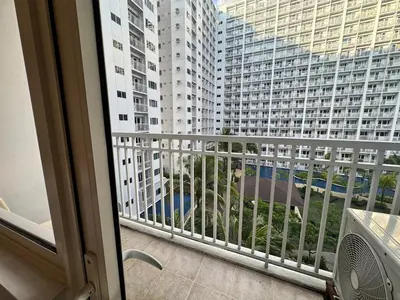 a balcony with a view of a large building at Shore Residences near Airport Blueberry Room 2 Beds Pool View by Prime Stay Room 628 in Manila
