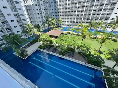 an overhead view of a swimming pool with palm trees and buildings at Shore Residences near Airport Blueberry Room 2 Beds Pool View by Prime Stay Room 628 in Manila