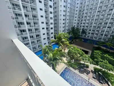 an overhead view of a swimming pool in front of tall buildings at Shore Residences near Airport Blueberry Room 2 Beds Pool View by Prime Stay Room 628 in Manila