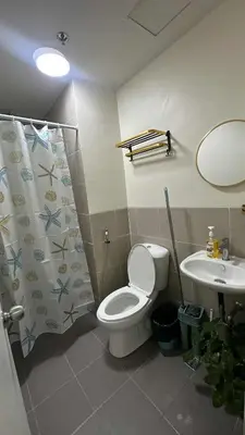 a bathroom with a toilet and a sink at Seb and Santi Holland Park Staycation in Biñan