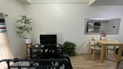 a living room with a table and a dining room at Seb and Santi Holland Park Staycation in Biñan