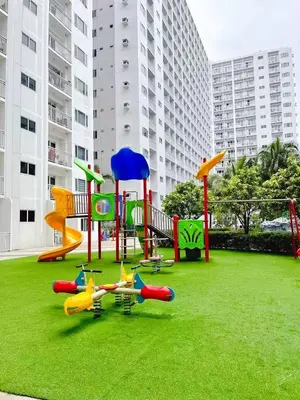 a playground with colorful play equipment on the grass at SHORE 2 TOWER 2 NEAR MOA 16TH Floor in Manila