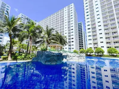 a swimming pool with blue water in front of tall buildings at SHORE 2 TOWER 2 NEAR MOA 16TH Floor in Manila