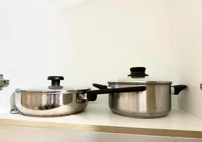 two pots and pans sitting on a kitchen stove at SHORE 2 TOWER 2 NEAR MOA 16TH Floor in Manila