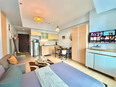 a kitchen and living room with a couch and a table at Pod to Go in Manila