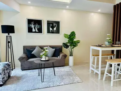 a living room with a couch and a table at Pod to Go in Manila