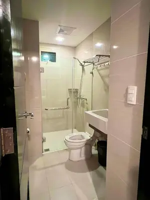 a bathroom with a shower and a toilet and a sink at Casa Haraya Urban Stays - Walking Distance to NAIA Terminal 3 Newport City Condo with 500mbps WIFI and free Netflix access in Manila
