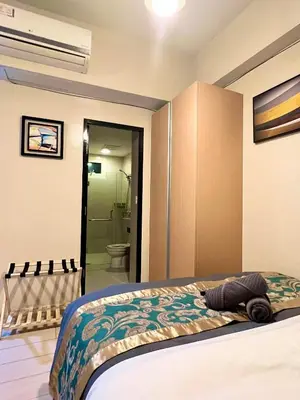 a bedroom with a bed and a bathroom at Casa Haraya Urban Stays - Walking Distance to NAIA Terminal 3 Newport City Condo with 500mbps WIFI and free Netflix access in Manila