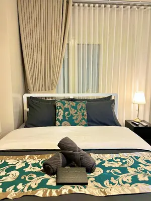 a bedroom with a bed with a pillow on a rug at Casa Haraya Urban Stays - Walking Distance to NAIA Terminal 3 Newport City Condo with 500mbps WIFI and free Netflix access in Manila