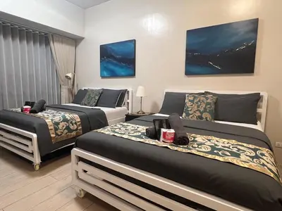 a bedroom with two beds and a window at Casa Haraya Urban Stays - Walking Distance to NAIA Terminal 3 Newport City Condo with 500mbps WIFI and free Netflix access in Manila