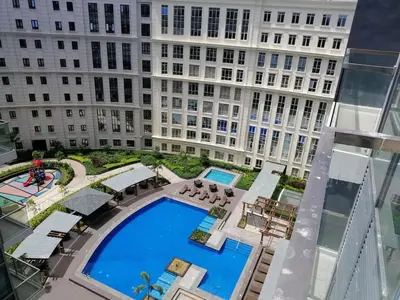 a view of a pool in front of a building at Casa Haraya Urban Stays - Walking Distance to NAIA Terminal 3 Newport City Condo with 500mbps WIFI and free Netflix access in Manila