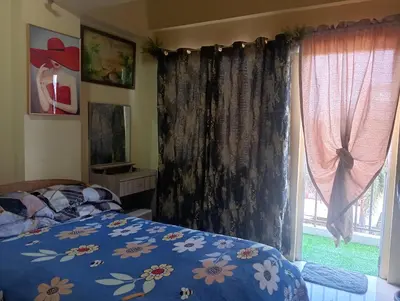 a bedroom with a bed and a window at Deviente's Guesthouse in Manila
