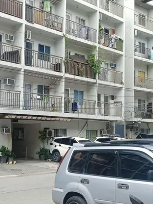 a car parked in front of a large apartment building at Deviente's Guesthouse in Manila