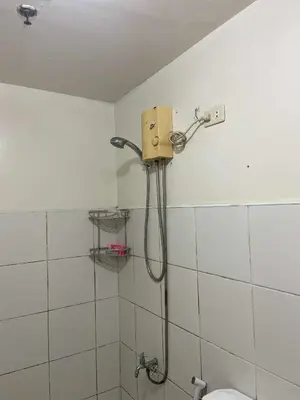 a shower in a bathroom with a shower head at Deviente's Guesthouse in Manila