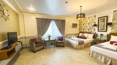 a hotel room with a bed and a television at Miramar Hotel in Manila