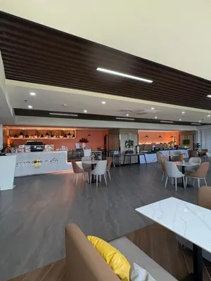 a lobby with tables and chairs and a restaurant at Sybay suites beside okada manila near AirPort MOA COD MSV1807H in Manila