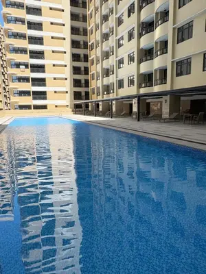 an empty swimming pool in front of buildings at Sybay suites beside okada manila near AirPort MOA COD MSV1807H in Manila