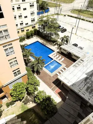 an overhead view of a swimming pool in front of a building at JFam Suites, C4-11K Studio, Up To 4 Pax in Biñan