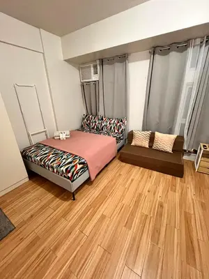 a room with a bed and a couch in it at JFam Suites, C4-11K Studio, Up To 4 Pax in Biñan