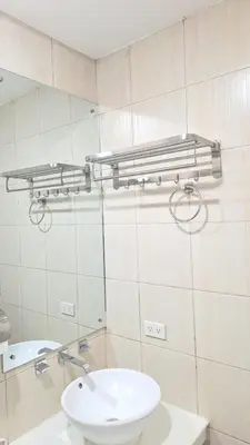 a bathroom with a sink and a mirror at Birch Tower Big Studio Type Unit 2711 in Manila