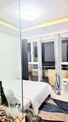 a bedroom with a large bed with a mirror at Birch Tower Big Studio Type Unit 2711 in Manila