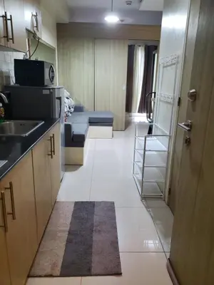 a room with a kitchen with a sink and a room with a unintention at La Luz - SMDC Breeze Residences in Manila