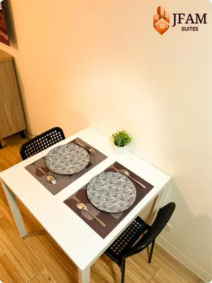 two plates on a white table with two chairs at JFam Suites, C3-9D Studio, Up To 4 Pax in Biñan