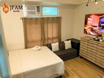 a small room with a bed and a dresser at JFam Suites, C3-9D Studio, Up To 4 Pax in Biñan