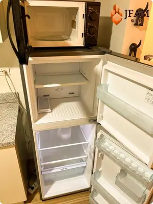 an open refrigerator with a microwave on top of it at JFam Suites, C3-9D Studio, Up To 4 Pax in Biñan
