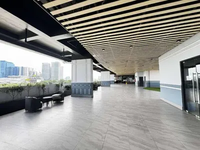 an empty lobby of an office building with a large ceiling at Modern 1 bedroom w Pool and City Views in Manila
