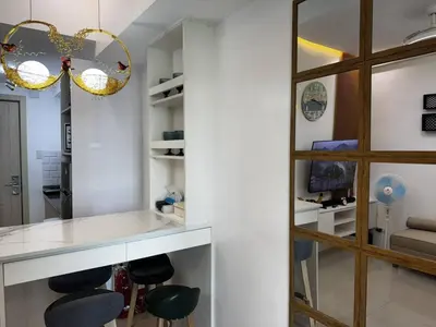 a kitchen with a counter and stools in a room at Modern 1 bedroom w Pool and City Views in Manila