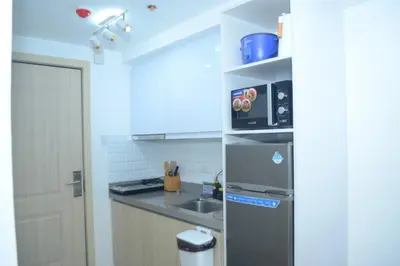 a kitchen with a stainless steel refrigerator and a sink at Modern 1 bedroom w Pool and City Views in Manila