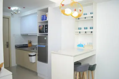a kitchen with white walls and a counter with a sink at Modern 1 bedroom w Pool and City Views in Manila