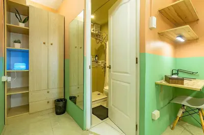 a small bathroom with a shower and a sink at Economy Room with Private Bath near LRT Santolan Pasig in Manila