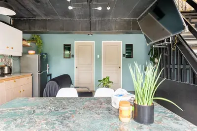 a kitchen with a table in a room at Economy Room with Private Bath near LRT Santolan Pasig in Manila