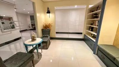 a living room with a table and chairs in a room at AdahkuMaya Luxury Suites in Manila