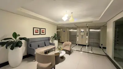 a living room with a couch and a table and chairs at AdahkuMaya Luxury Suites in Manila