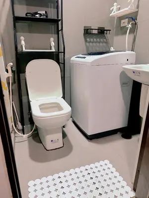 a bathroom with a toilet and a sink at Makati City Ph SnowWhite Staycation in Manila