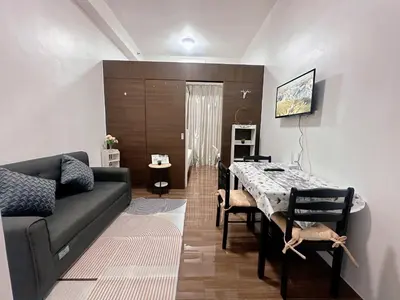 a living room with a couch and a table at Makati City Ph SnowWhite Staycation in Manila