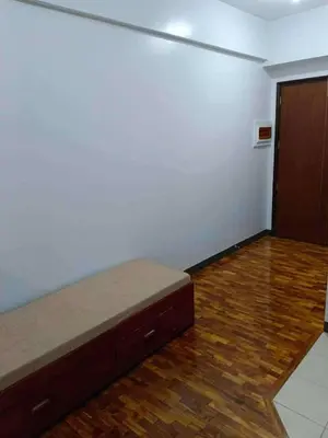 a room with a bed in the corner of a room at The orienthal place, Makati a1 in Manila
