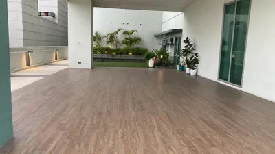 an empty hallway with a wooden floor in a building at The Olive Place, Manadaluyong City in Manila