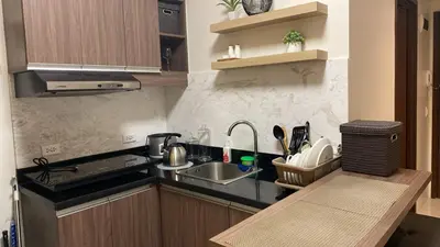 a small kitchen with a sink and a counter at The Olive Place, Manadaluyong City in Manila