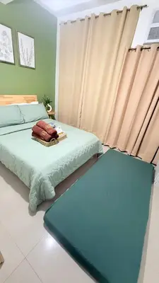 a bedroom with two beds and a window at Harbour Park Residences Cozy 1BR Suite in Manila