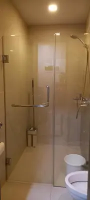 a bathroom with a glass shower with a toilet at Megaworld in Manila